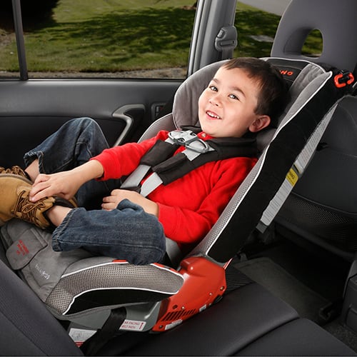 Kid Car | happy child safely secured in a vehicle